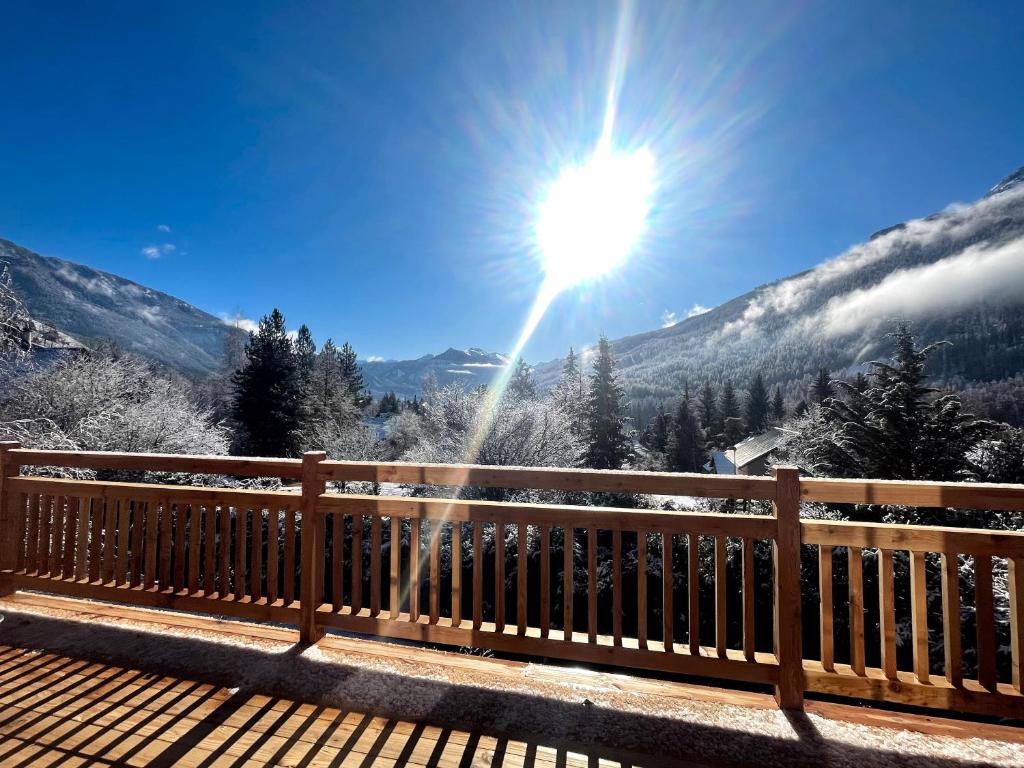 a view of the mountains with the sun in the sky at South-facing Chalet With Views in Le Villard-Late