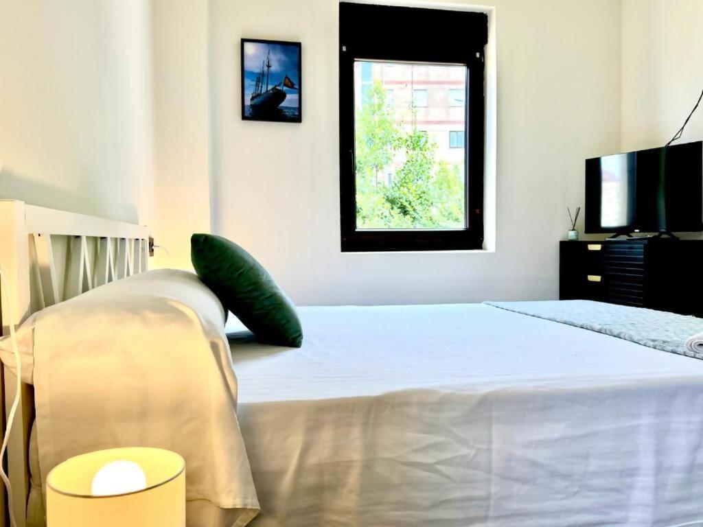 a bedroom with a bed and a television at Santander suites and rooms atlántico in Santander
