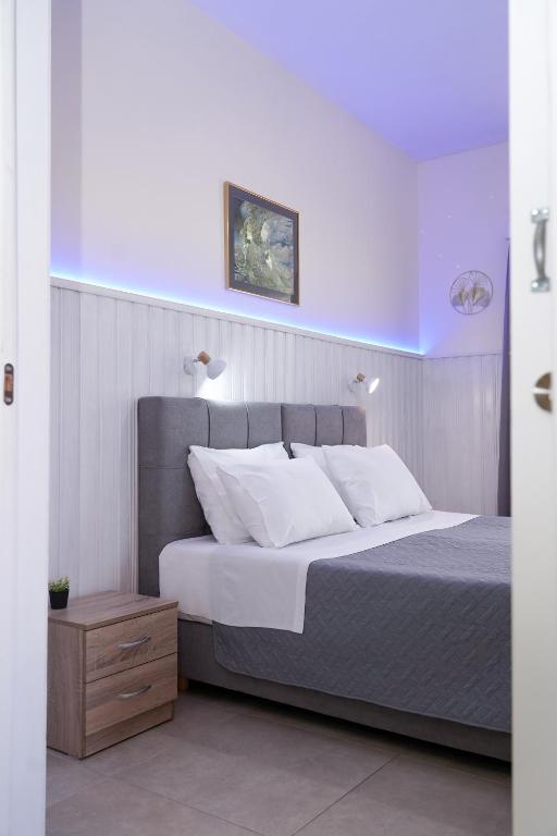a bedroom with a large bed with white pillows at Ipsos Wave Apartments in Ipsos