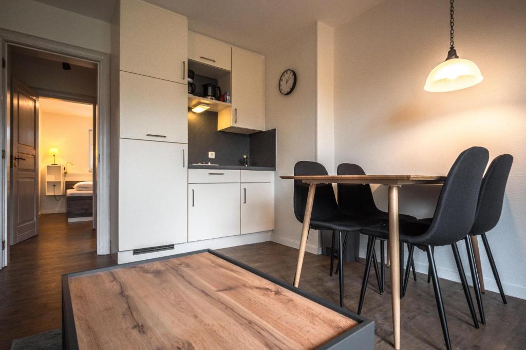 a kitchen and dining room with a table and chairs at Deichkoje 1 Dagebüll in Dagebüll