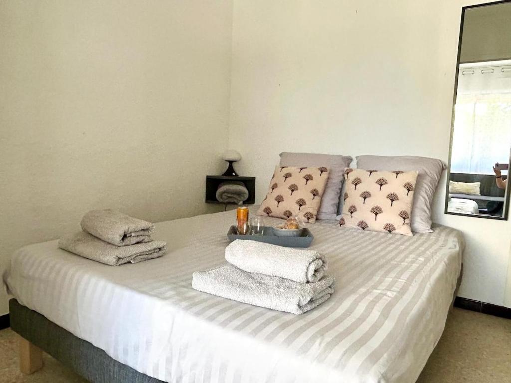 a bed with towels and a tray on top of it at Large Studio with sleeping area in Carnon-Plage
