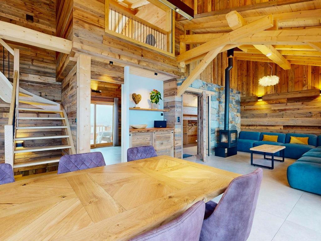a dining room with a wooden table and chairs at Chalet 5* avec spa, sauna et jacuzzi pour 15 pers., accès pistes - FR-1-267-310 in Villarembert