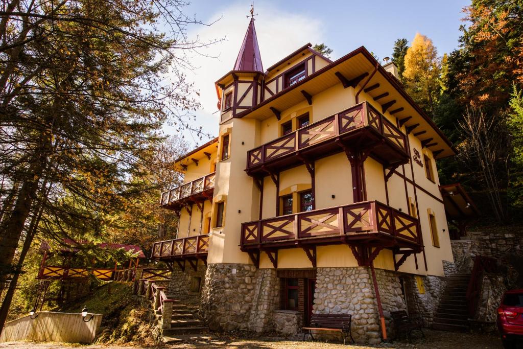 un vieux bâtiment avec une cloche en haut dans l'établissement Villa Rusalka, à Vysoké Tatry