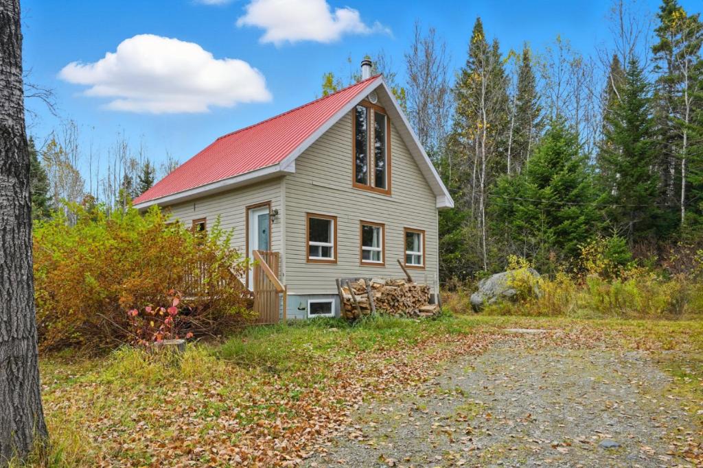 a small white house with a red roof at The Tiny Cozy Retreat in Saint-Just-de-Bretenières