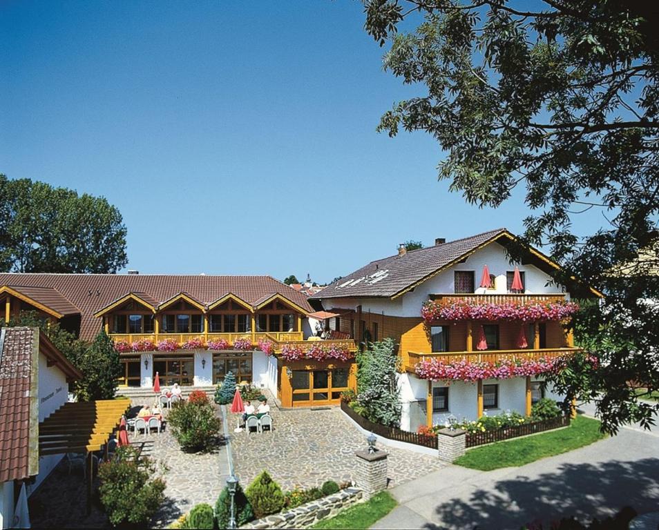 a large house with flowers on the front of it at Ferienhotel Münch in Neukirchen beim Heiligen Blut