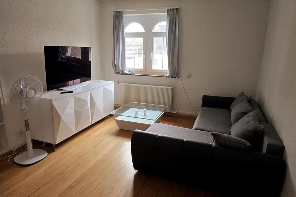 a living room with a couch and a flat screen tv at Helle, gemütliche Wohnung an der grenze vom Deutschland in Koblenz