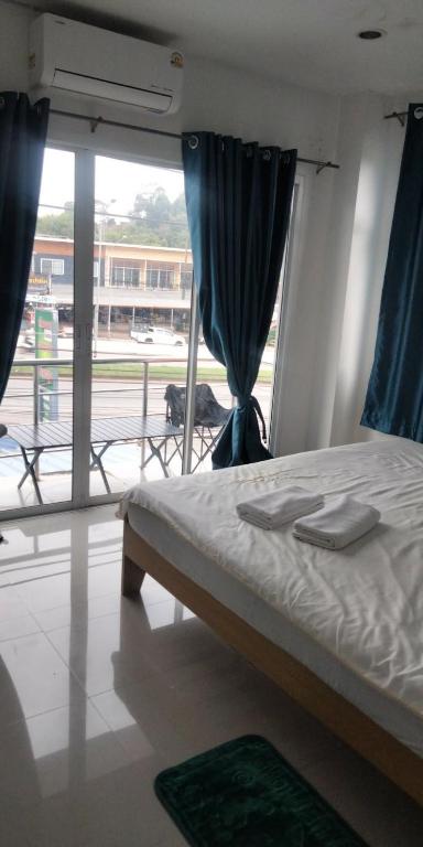 a bedroom with a bed and a view of an airport at อิงเขาค้อ in Campson
