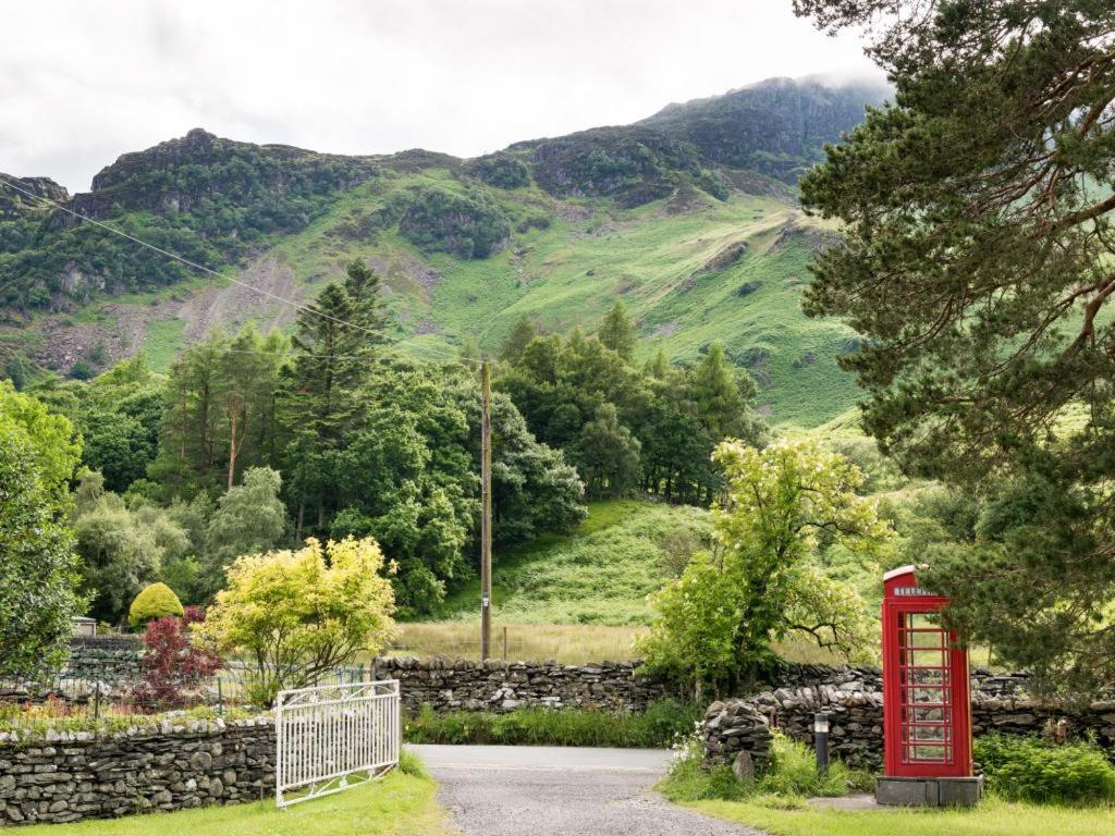a red phone booth in front of a mountain at 4 Bed in Keswick oc-sz219 in Grange