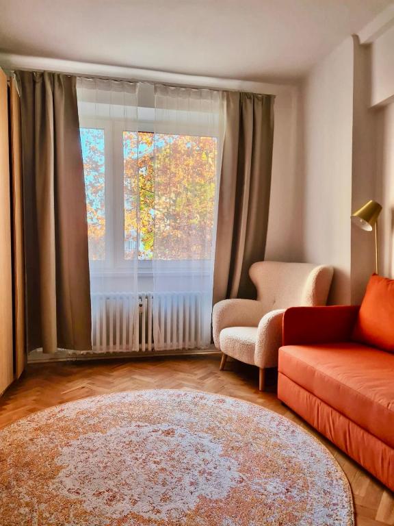 a living room with a couch and a window at City-Centre appartment in Piešťany