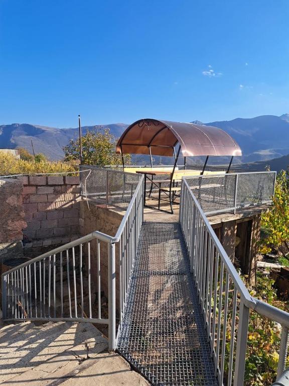 a bridge with a picnic table and a gazebo at Elmira B&B in Tatʼev