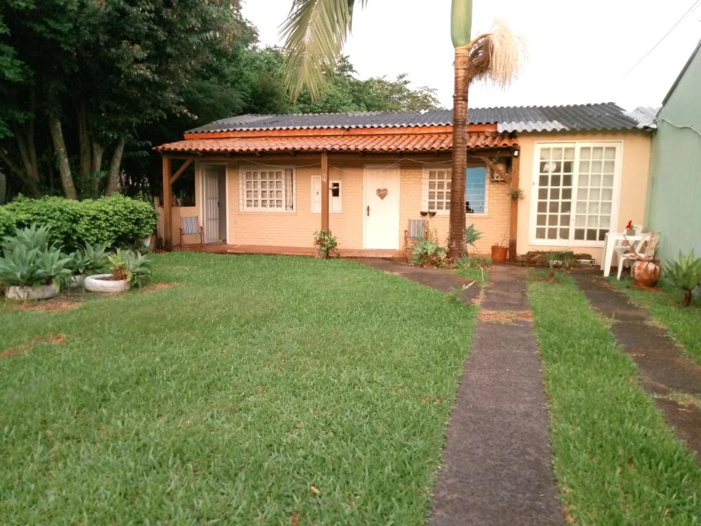 a house with a grass yard in front of it at next to UNISC in Santa Cruz do Sul