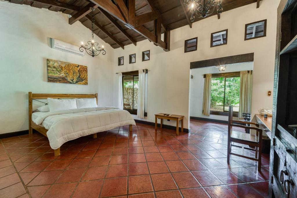 a bedroom with a bed and a tiled floor at Hacienda La Pacífica Eco-Lodge in Cañas