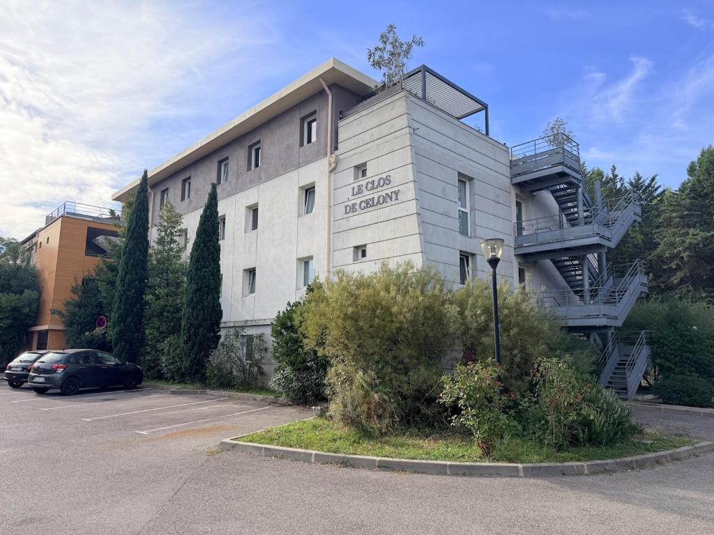 a building with a spiral staircase on the side of it at Clos d'AIX studio 11 in Aix-en-Provence