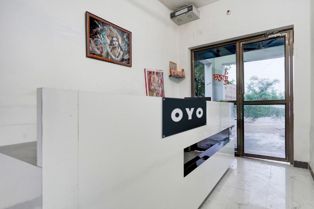 a white room with an ovy sign on a wall at SPOT ON New Phulpur Restaurant And Hotel in Phūlpur