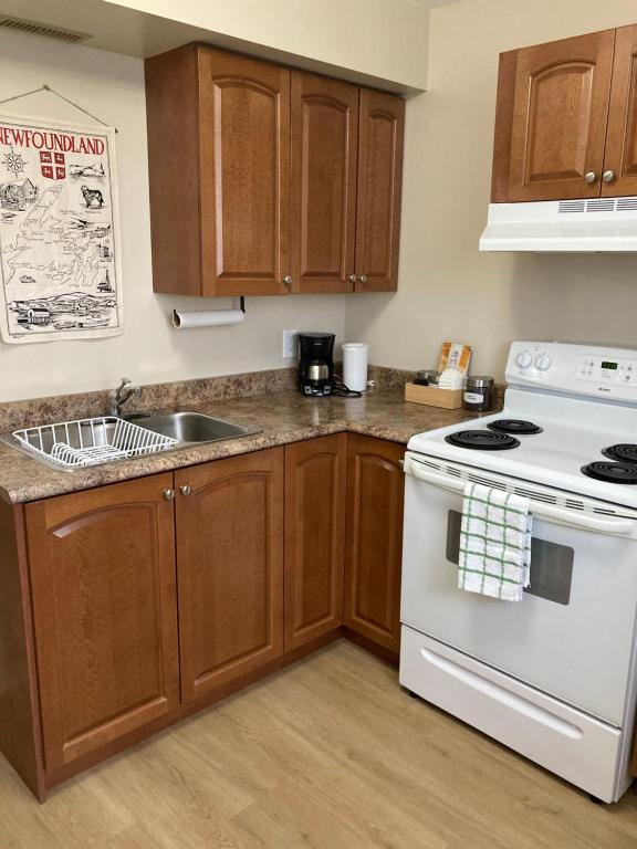 a kitchen with a white stove and a sink at The Gateway Suite in Fortune