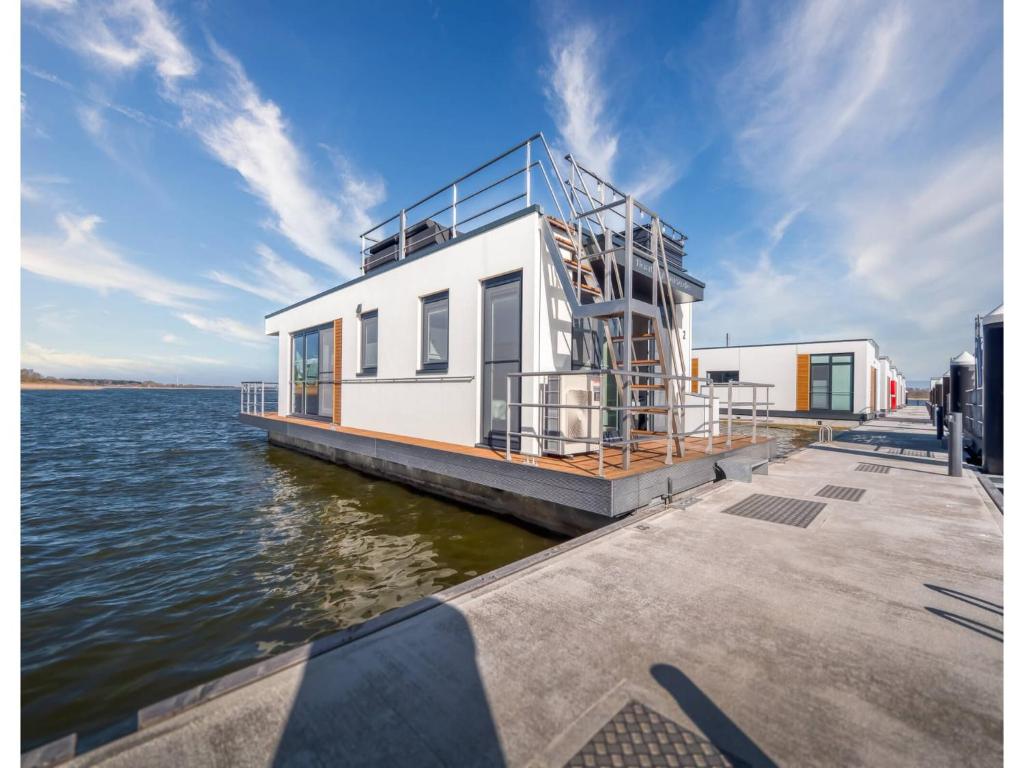 a house on a dock on the water at Bright Base with Coastal Access in Ribnitz-Damgarten