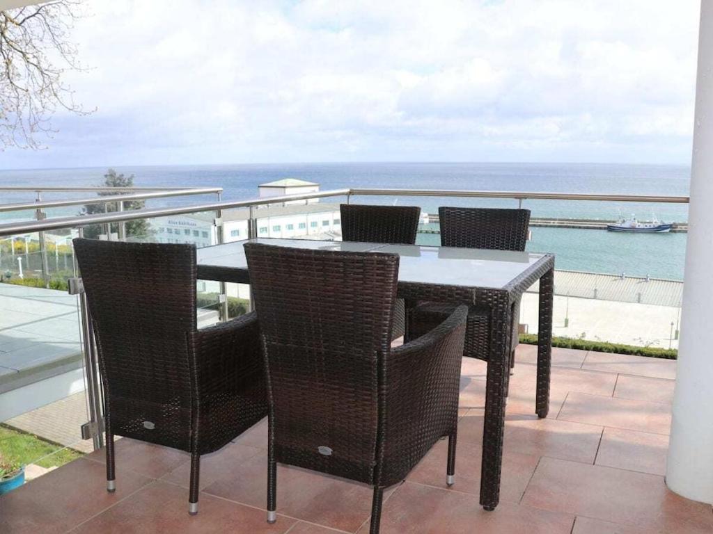 Freya - with breathtaking sea views في ساسنيتز: طاولة وكراسي على شرفة مطلة على المحيط