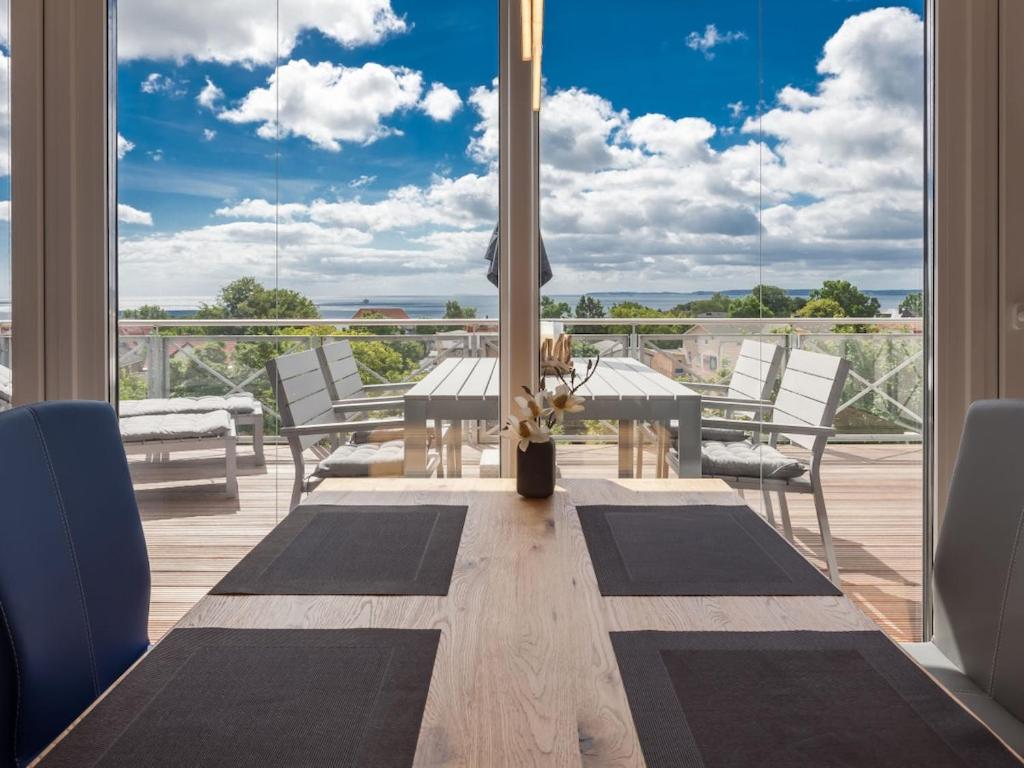 a dining room with a table and chairs and windows at One-bedroom apartment in Sassnitz