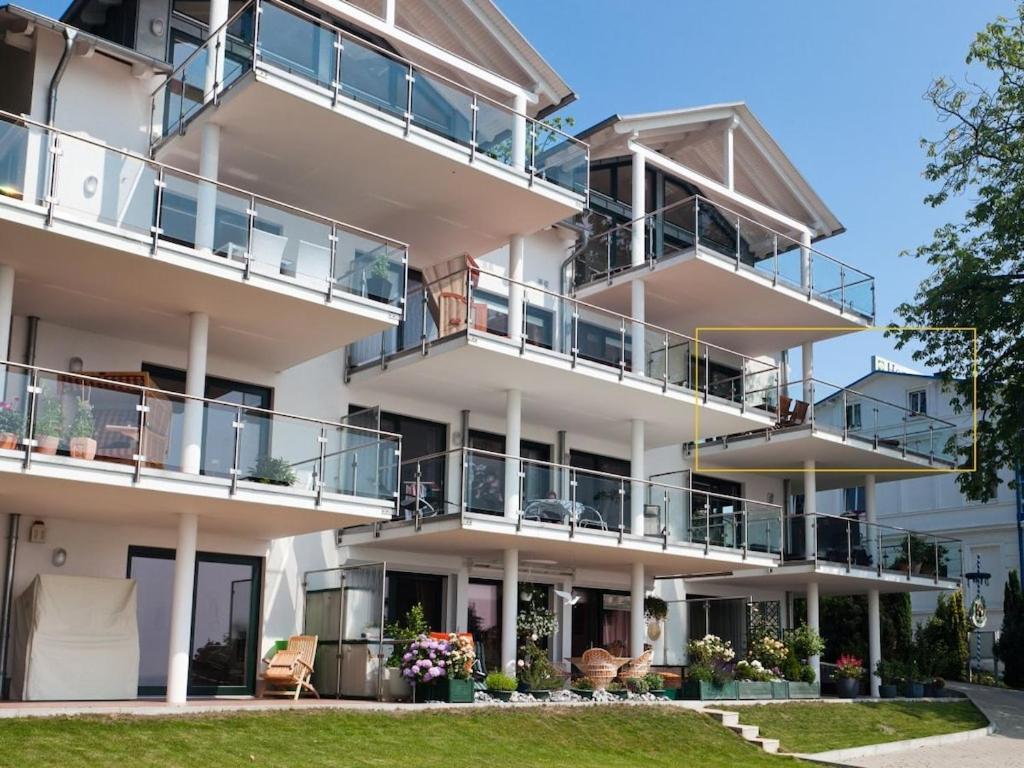 an apartment building with balconies and a lawn at One-bedroom apartment in Sassnitz