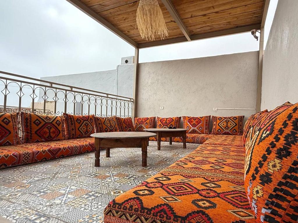 a room with couches and a table and a rug at Soul Surf House in Agadir