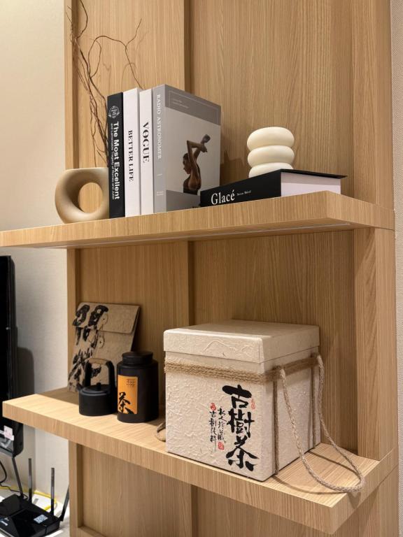 a shelf with books and other items on it at M Luna Residence in Kuala Lumpur
