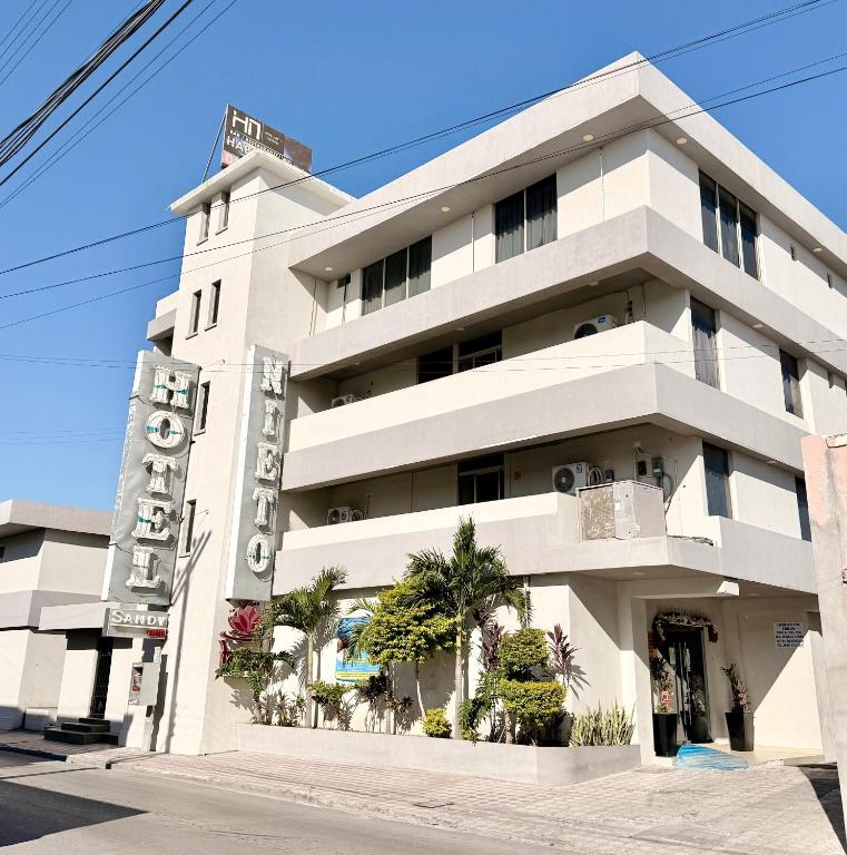 a white building with a sign in front of it at Hotel Nieto Express in Matamoros