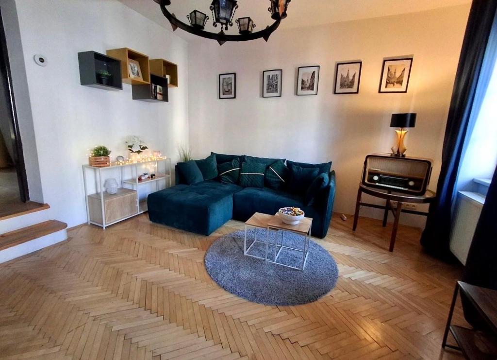 a living room with a blue couch and a table at Central Modern Studio - wifi, coffee in Bratislava