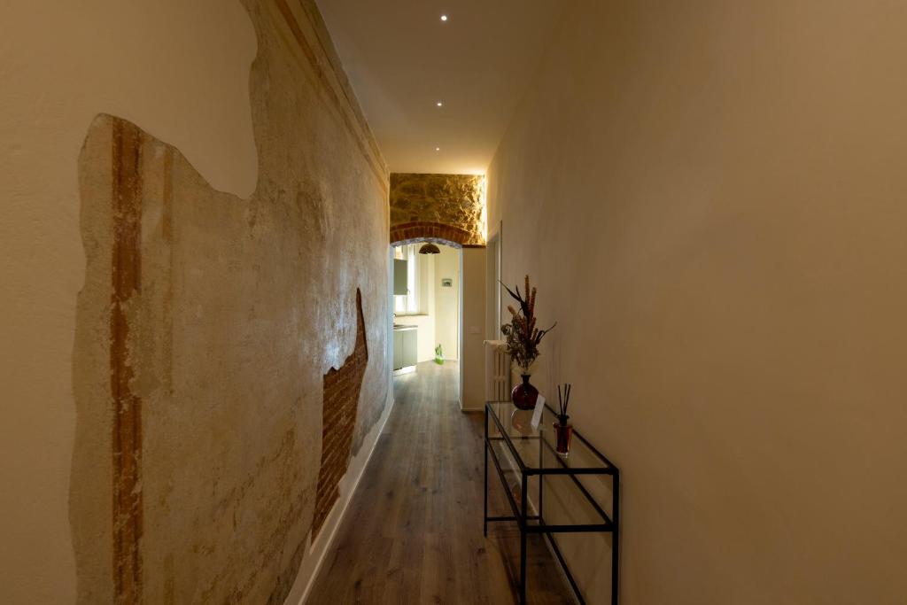 a hallway with a staircase and a room with a wall at La Casina del Popi in Arezzo