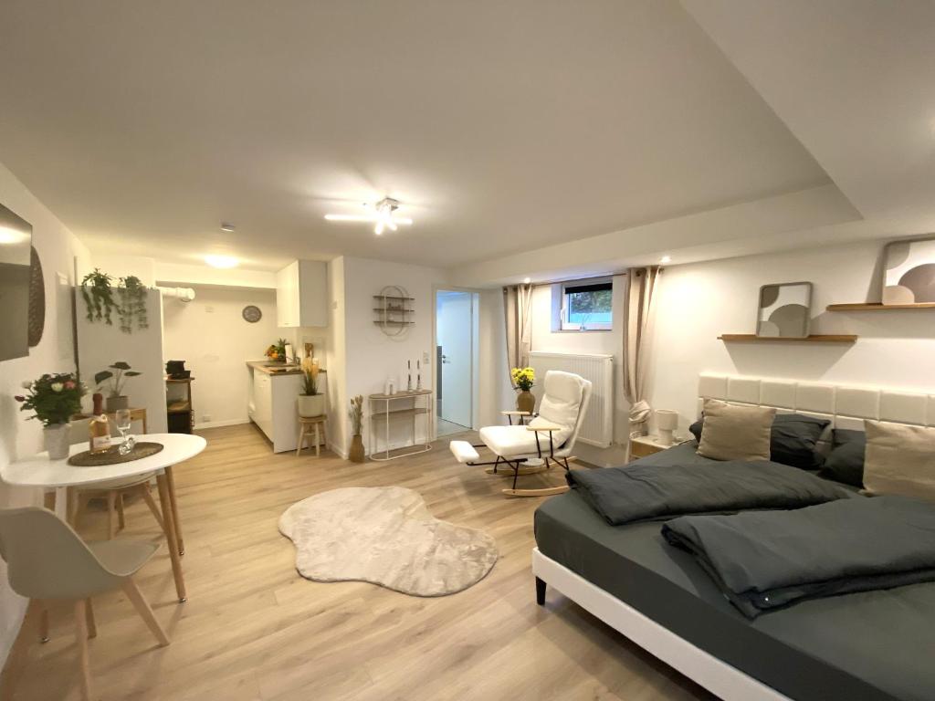 a bedroom with a bed and a living room at Allgäu-Nest mit Stellplatz in Durach