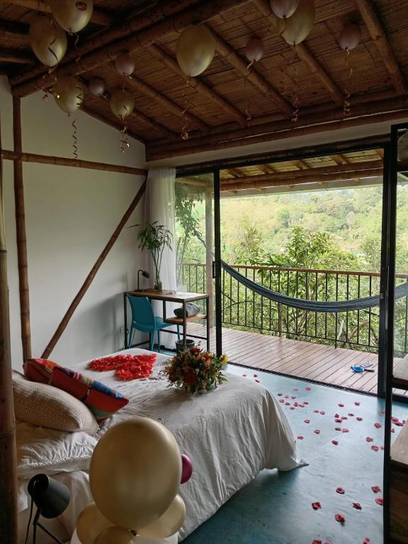 a bedroom with a bed in a room with a balcony at Cabane Araza - Salento in Salento