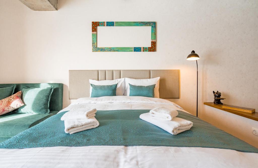 a bedroom with a bed with towels on it at New Gudauri Ski4Life in Gudauri