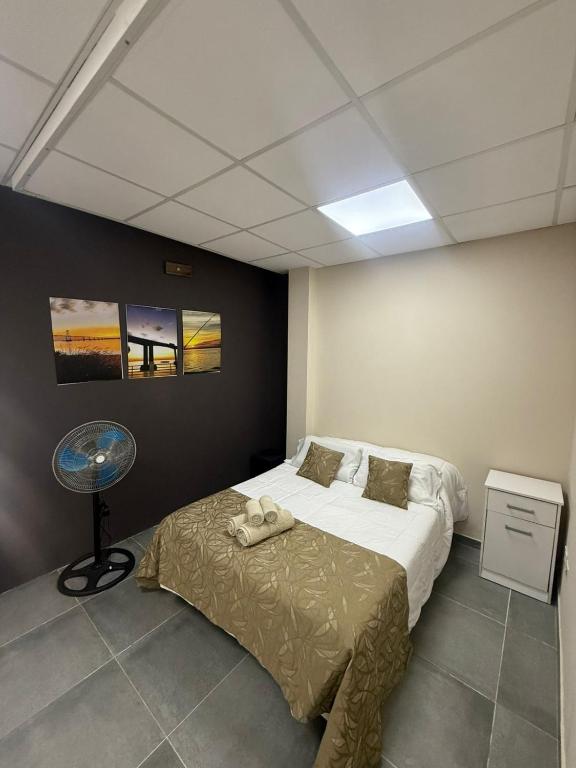 a bedroom with a bed and a table in it at Dpto CORRIENTES, Planta BAJA in Corrientes