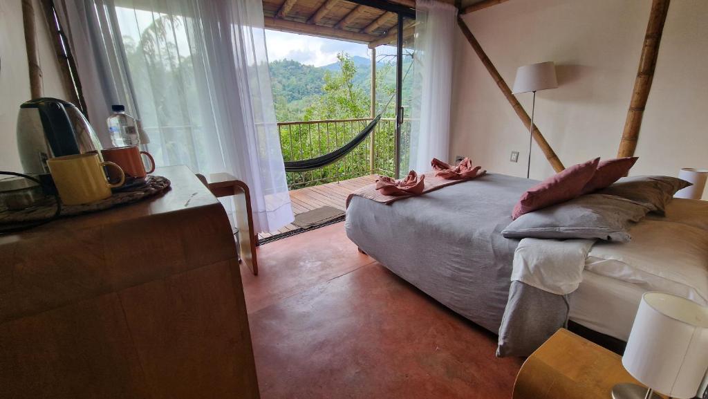 a bedroom with a bed and a large window at Cabane Limon - Salento in Salento