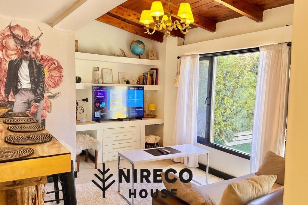 a living room with a couch and a table at Ñireco HOUSE in San Carlos de Bariloche