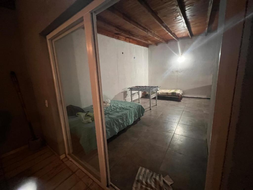 a reflection of a bedroom with a bed and a mirror at Quinta Los Barrera in Cañuelas