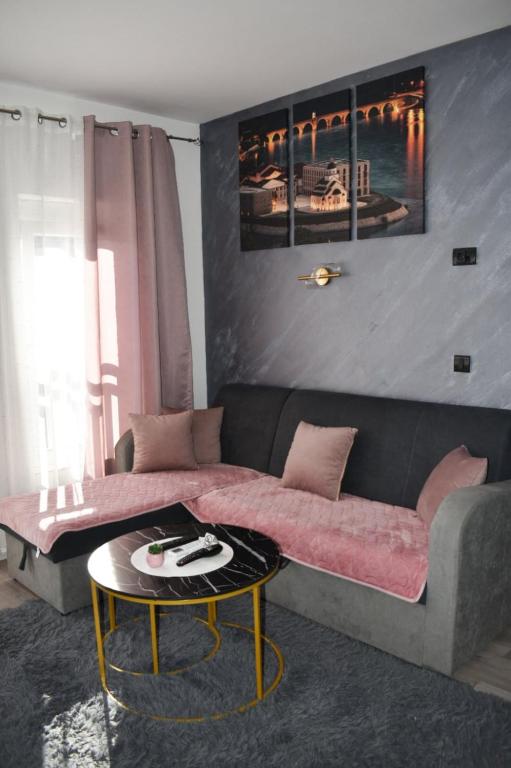 a living room with a couch and a table at Apartman Palermo in Višegrad