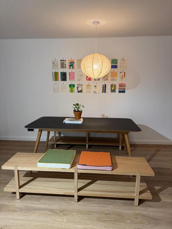 a table and bench with mats on it in a room at Wohnen im alten Standesamt High 5 in Pasewalk