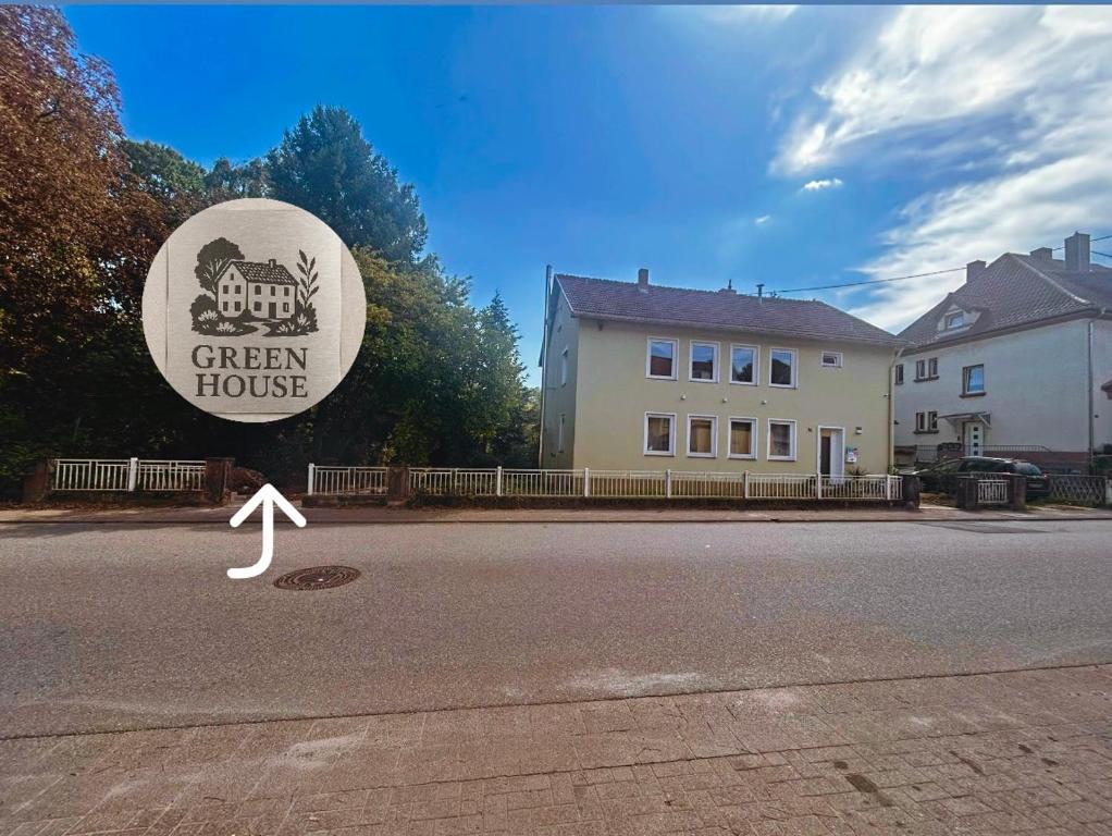 a sign for a green house on the side of a street at Green House in Neunkirchen