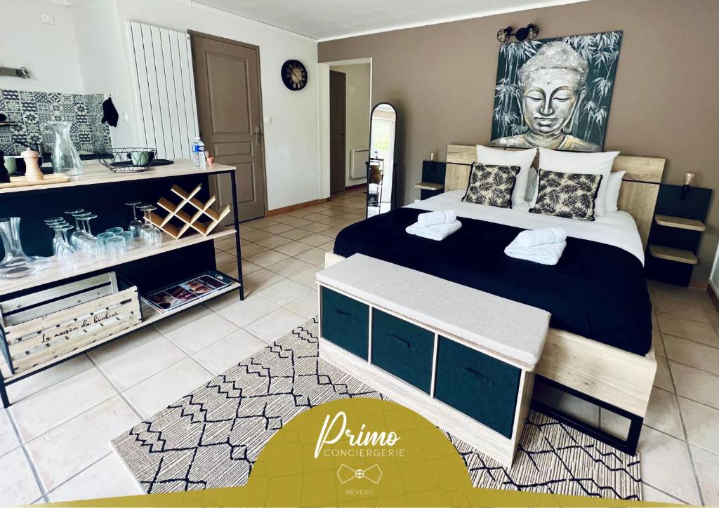 a bedroom with a large bed with a painting on the wall at "Le studio Bouddha" Studio avec terrasse, centre ville, proche gare, by PRIMO C0NCIERGERIE in Nevers