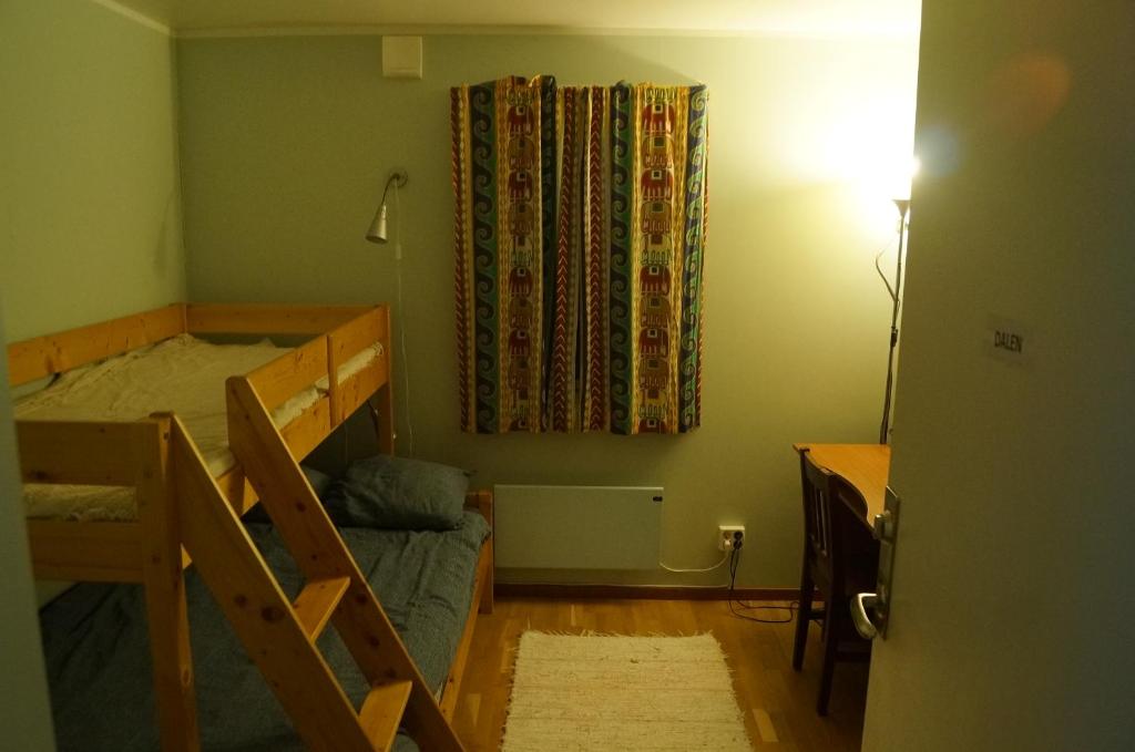 a bedroom with a bunk bed and a window at Laplanders room 1 in Kiruna