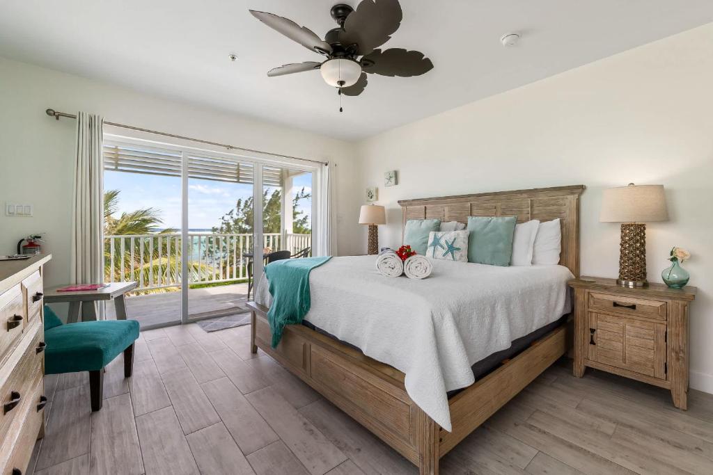 a bedroom with a bed and a balcony at The Starfish at Cottages in Sand Bluff
