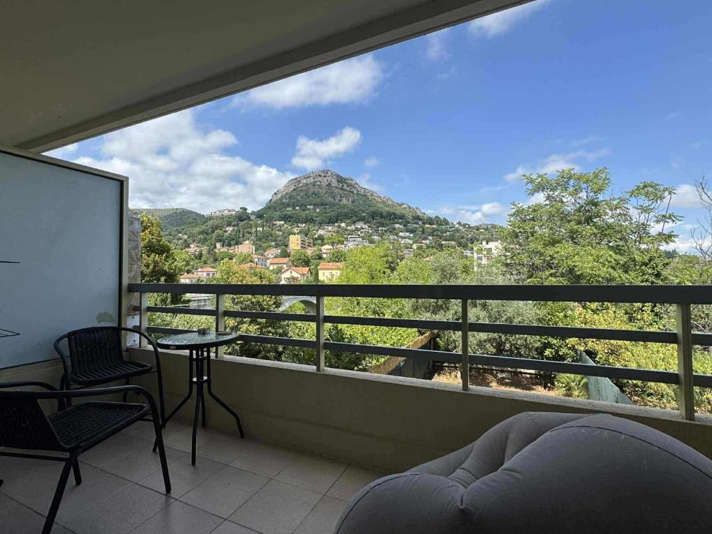 a room with a balcony with a view of a mountain at Vue Panoramique Vence Balcon & Calme in Vence