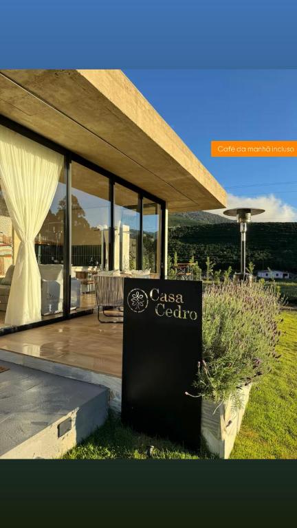 a house with a sign that says casa colato at Casa Cedro in Espera Feliz