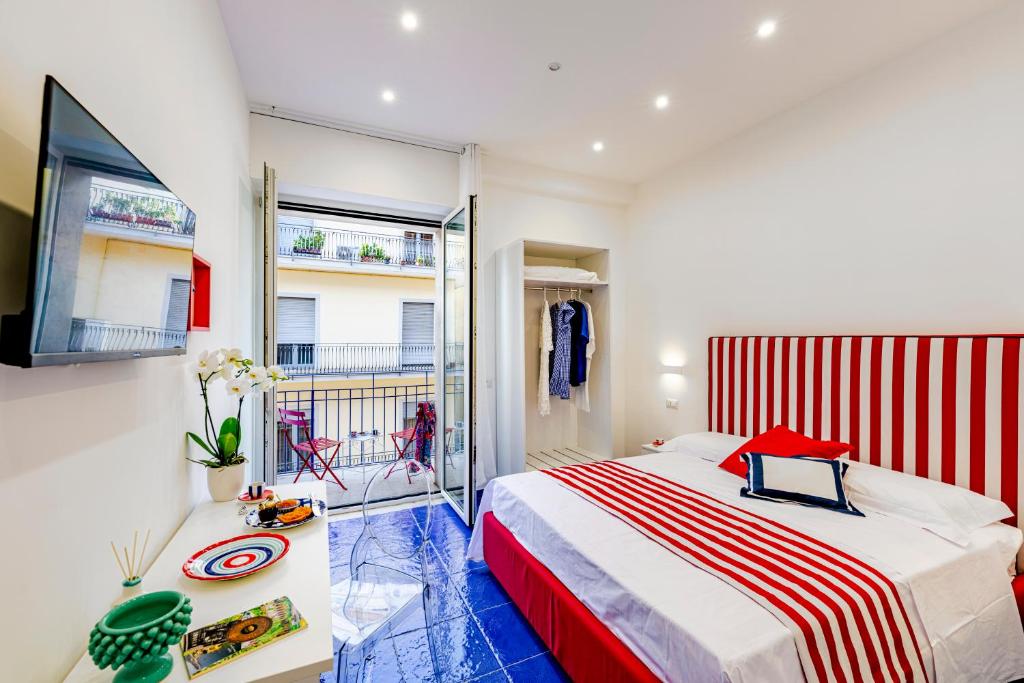 a bedroom with a large bed and a balcony at Bellamore in Piano di Sorrento