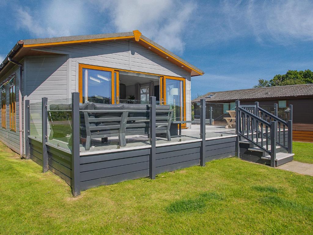 a small house with a porch and a deck at 36 At The Sanctuary - Uk50278 in Carnguwch