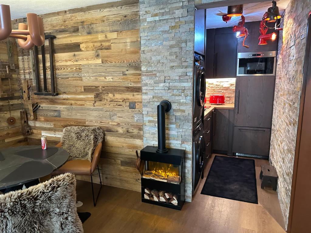 a woodburning stove in a room with a table at Zermatt Apartment in Zermatt