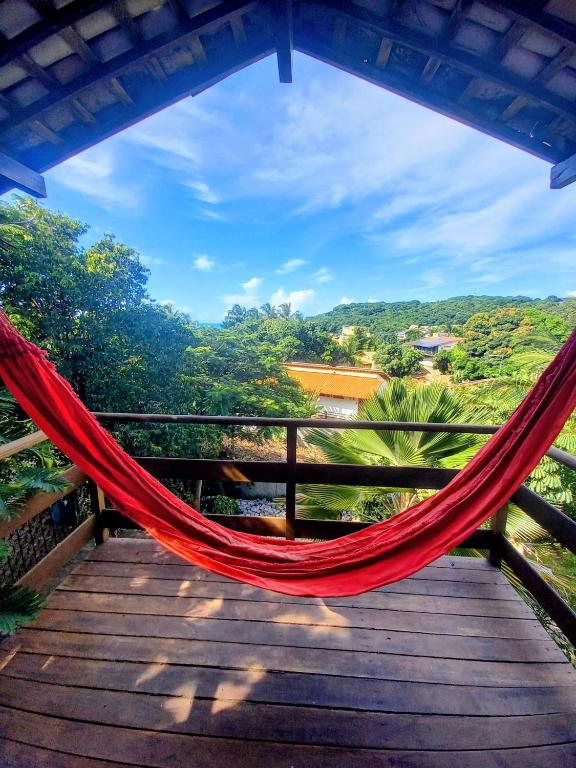 a hammock on a deck with a view at Stay Cool Pipa in Pipa