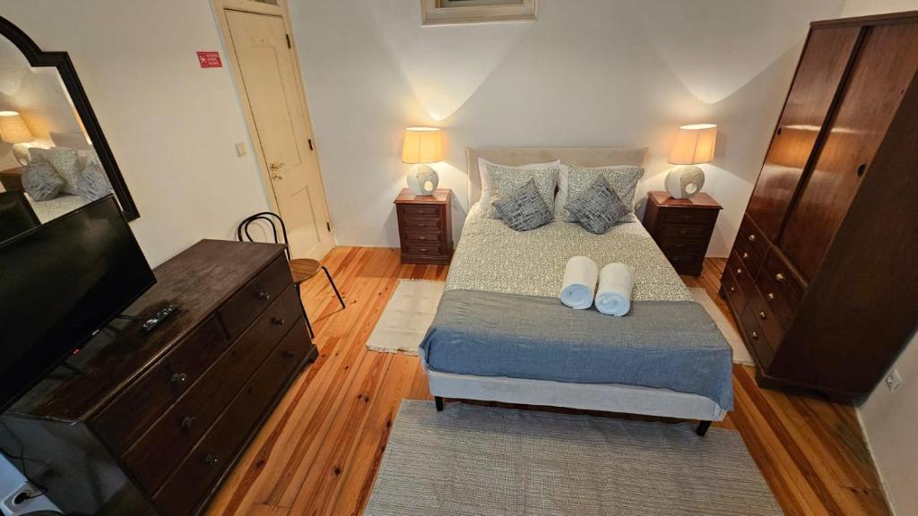 a bedroom with a bed and a dresser and two lamps at Costa do Castelo Lisbon Accomodation in Lisbon
