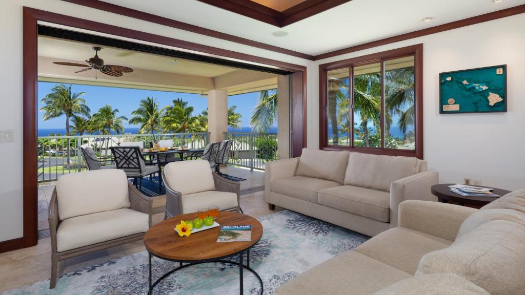 a living room with a couch and a table at ❤PiH❤ A Sea-nic Escape Stunning Ocean View Mauna Kea Resort eBikes in Hapuna Beach