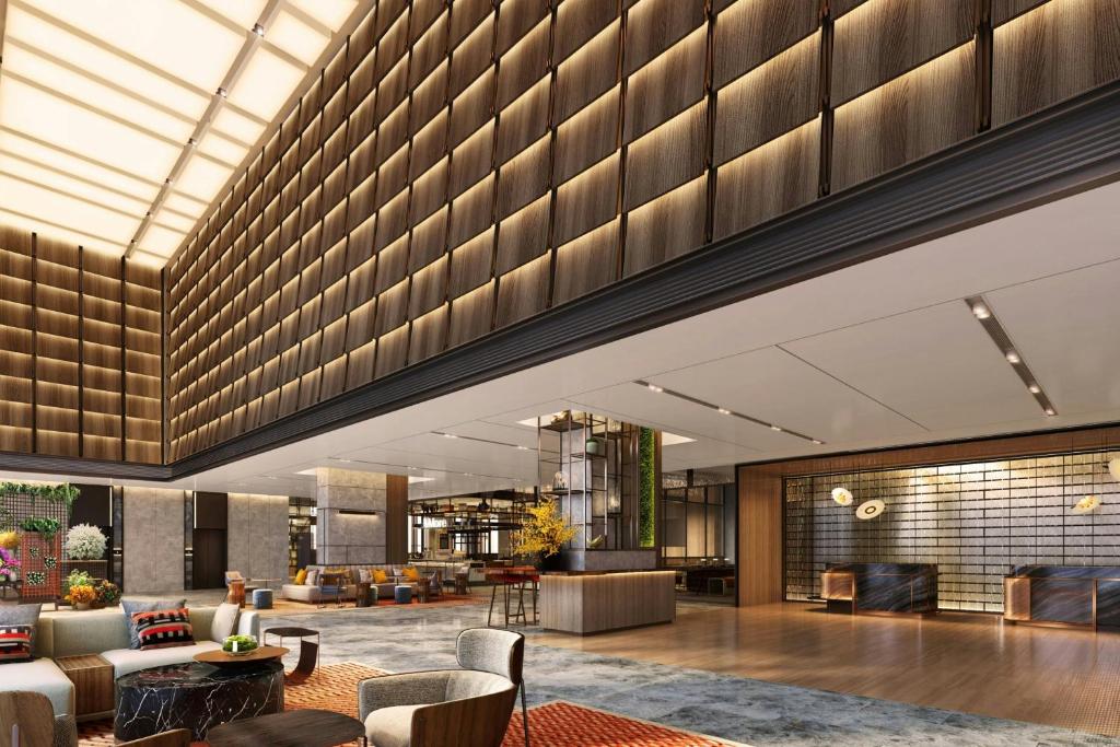 a lobby of a hotel with couches and tables at Sheraton Kota Kinabalu in Kota Kinabalu